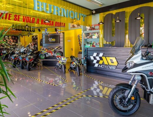 Showroom di AD Motors con esposizione di moto nuove e usate, accessori per motociclisti e area vendita con logo ben visibile. Servizi di officina e vendita ricambi.