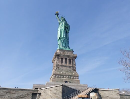 Statua della Libertà a New York, vista dal basso con cielo azzurro. Agenzia viaggi Valtravel per viaggi e vacanze.
