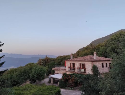 Agriturismo Monte Cesima, Italy: A scenic view of the stone building nestled amidst lush greenery, offering a tranquil travel destination.