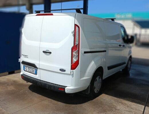 White Ford Transit Custom van at Mywash autolavaggio, rear view, license plate FZ 332XK, clean and shiny after carwash service.
