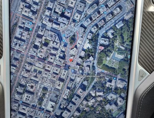 Map view on a car's display showing Piazza Gaetano Alimonda and surrounding streets in Italy; relevant for Autolavaggiotomaseo services