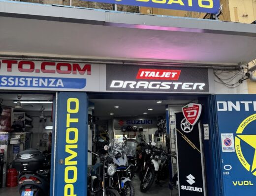 Showcase of Topomoto motorcycle shop featuring Benelli, GI.VI, SC PROJECT, and IXS brands, displaying new and used motorcycles, accessories, and offering service and marketplace options.