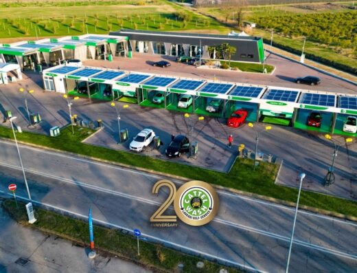 Vista aerea di Cattel Wash, autolavaggio self-service con pannelli solari, auto in fila per il lavaggio e logo del 20° anniversario.