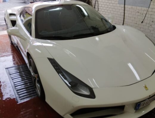 Di Lorenzo Giuseppe auto detailing: A white Ferrari 488 being washed at a professional car wash and detailing service.