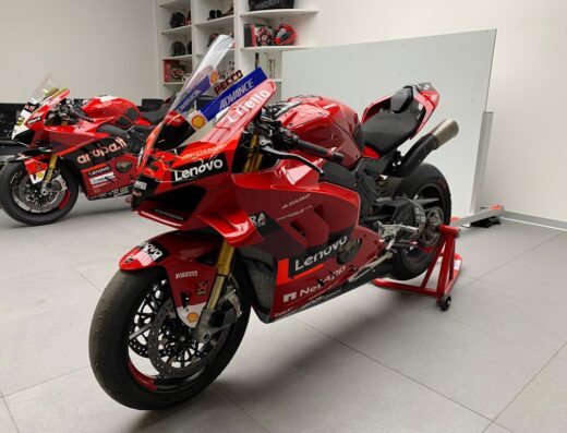 Ducati Panigale V4 in rosso Ducati su cavalletto, livrea con sponsor Lenovo, Pirelli e Shell, per competizioni e pista.