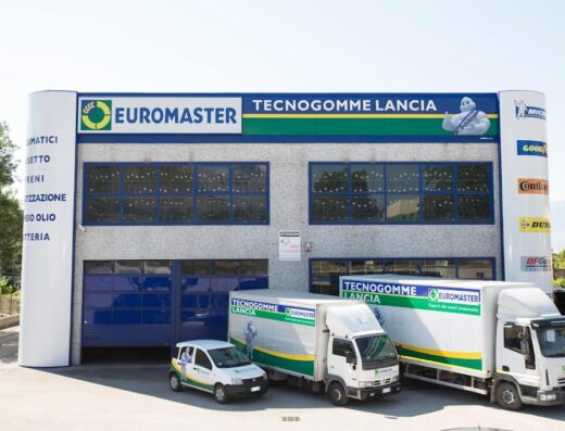 Euromaster Tecnogomme Lancia: officina specializzata in pneumatici e servizi auto. Furgoni e auto aziendali parcheggiati davanti all'edificio.