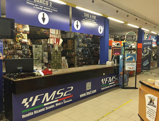 Interno del negozio FMS2: banco vendita ricambi scooter, moto e vespa. Vasta scelta di accessori e ricambi moto disponibili.