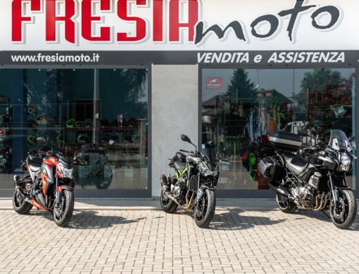 Tre motociclette Fresia Moto esposte davanti al negozio: modelli naked e da turismo in vendita e assistenza.