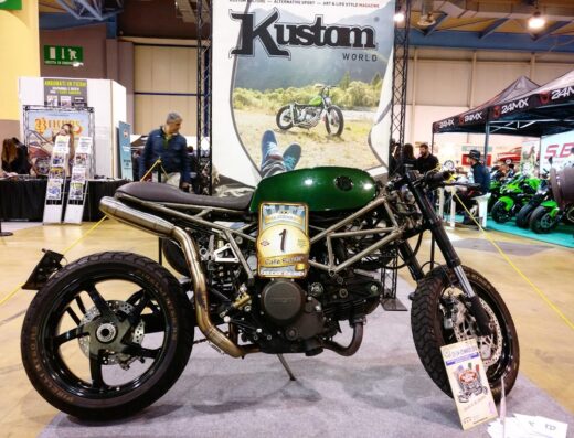 FTG Moto Milano: Una moto Cafe Racer Ducati verde personalizzata in mostra. Accessori moto artigianali e design esclusivo per appassionati di customizzazione. Mercato moto e servizi.