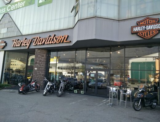 Harley-Davidson Bozen-Bolzano storefront featuring motorcycles on display outside the dealership, showcasing models and accessories available in Bolzano.