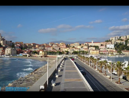 Panorama di Porto Maurizio, Imperia, con vista sul lungomare, la spiaggia, il borgo storico e il porto turistico pieno di barche