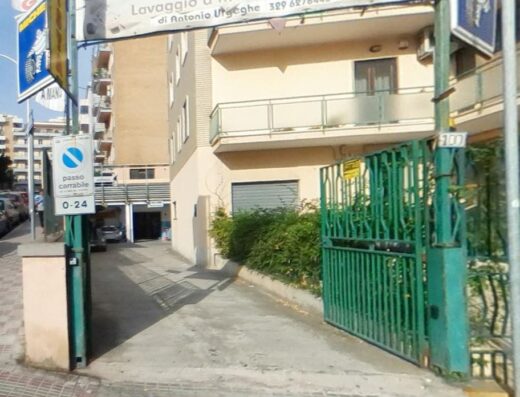 Ingresso de Il Punto Gomma, con cartello 'passo carrabile' e indicazioni per lavaggio auto a mano, servizio di Antonio Urseghe.