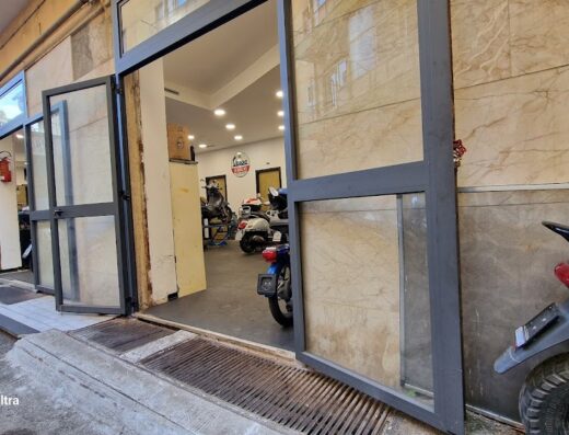 Moto Armando store front with motorcycles inside, showcasing services, accessories and motorcycle marketplace.