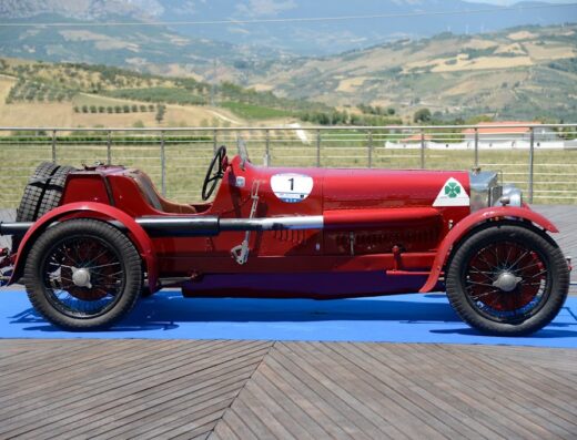 Classic red Alfa Romeo race car with number 1 on display at an vintage motors club event in Abruzzo, Italy; showcasing automotive history.