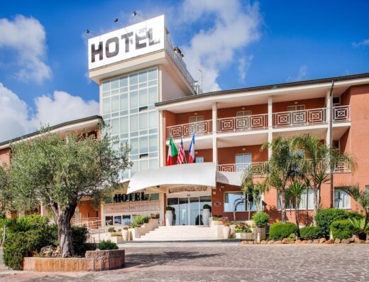 Ostia Antica Park Hotel Meeting Center & Spa exterior, featuring the hotel entrance, flags, and architectural details in Ostia Antica, Italy.