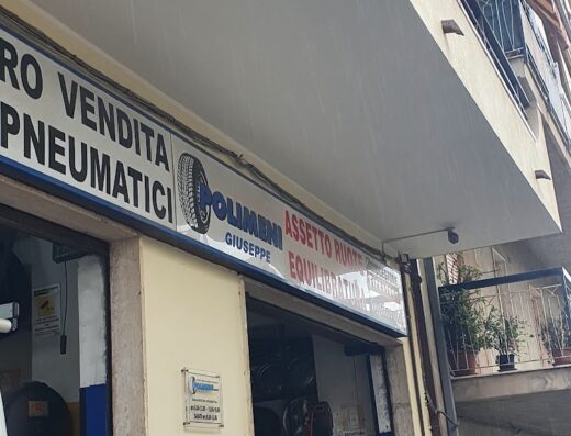 Polimeni Giuseppe tire shop storefront, offering motorcycle tire sales and service, wheel alignment, and balancing in an urban setting, featuring a visible tire display and service equipment.