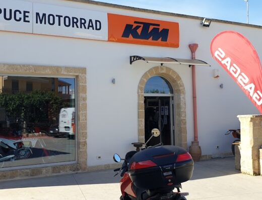 Puce Motorrad S.N.C. KTM Spongano storefront with motorcycle accessories and GasGas banner, showcasing KTM dealership and motorcycle sales.