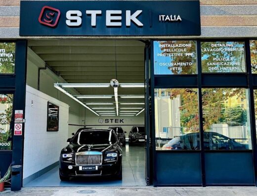 STEK Como Car Detailing storefront featuring luxury car inside for detailing, paint protection film (PPF), window tinting, premium washing, interior cleaning, polishing, and nanotech treatments.