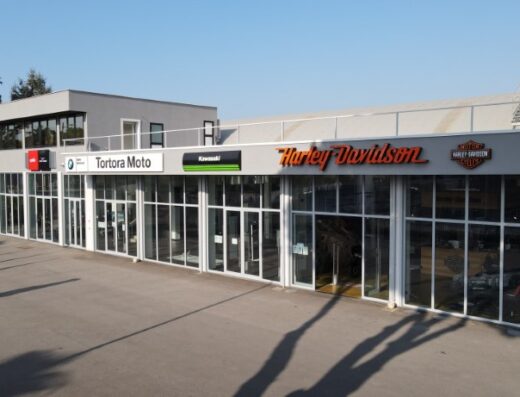 Tortora Moto dealership exterior showcasing brands like Harley-Davidson and Kawasaki, offering motorcycle sales, service, and accessories.