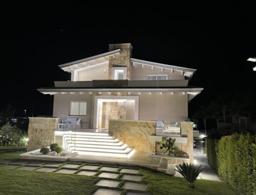 Villa Rocca Hotel B&B SPA in Pizzo, Calabria near Tropea, Italy: Exterior view at night with illuminated steps and manicured lawn.