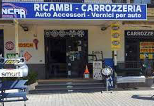 VinCar Ricambi store front featuring auto parts, accessories, and body shop services, including spare parts and car paints, displayed outside the store.