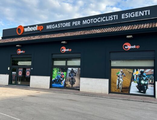 Wheelup megastore facade featuring images of motorcyclists riding different types of motorcycles, a marketplace for riders.